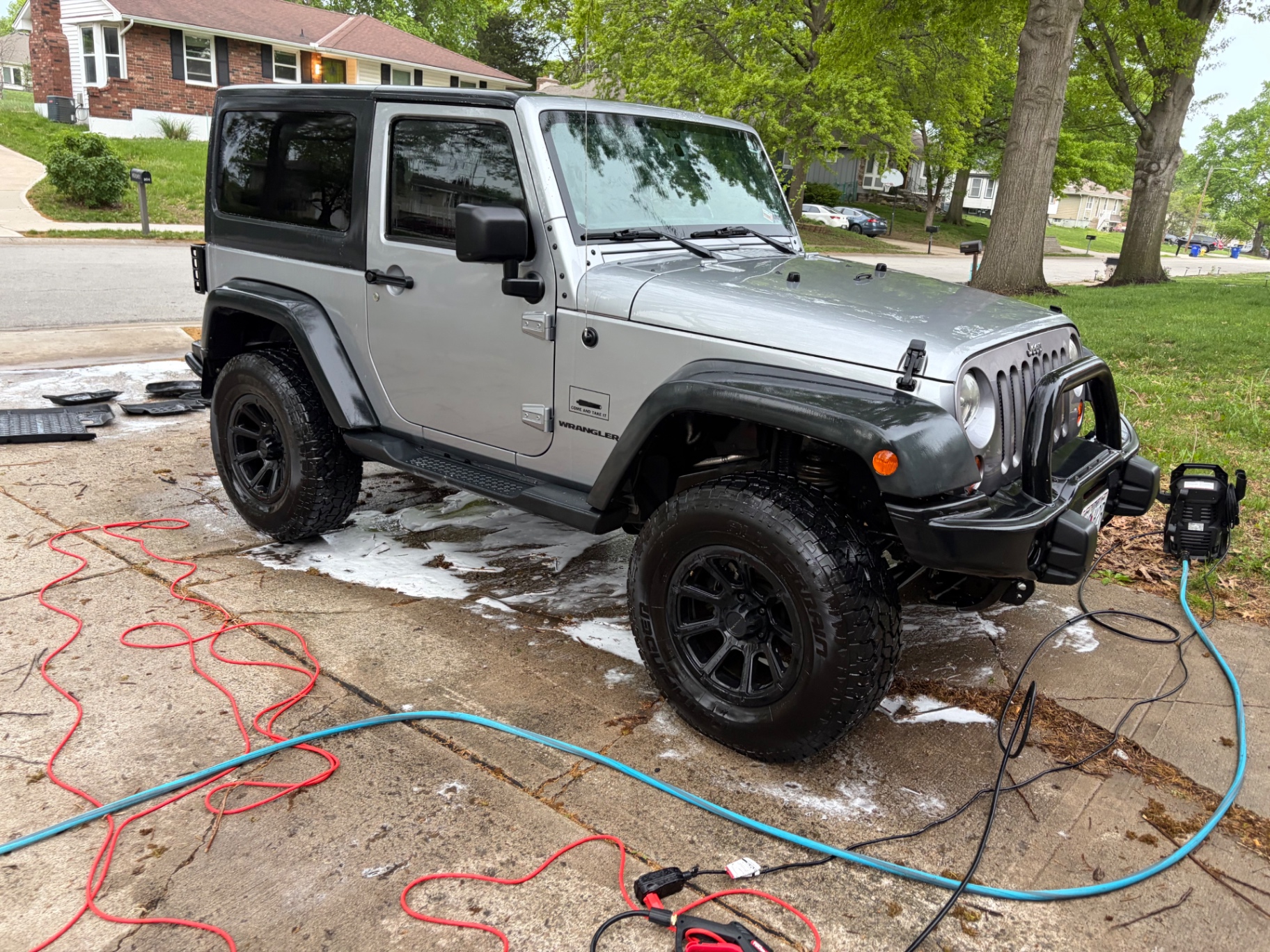 Silver Jeep Wrangler getting a foam exterior wash
