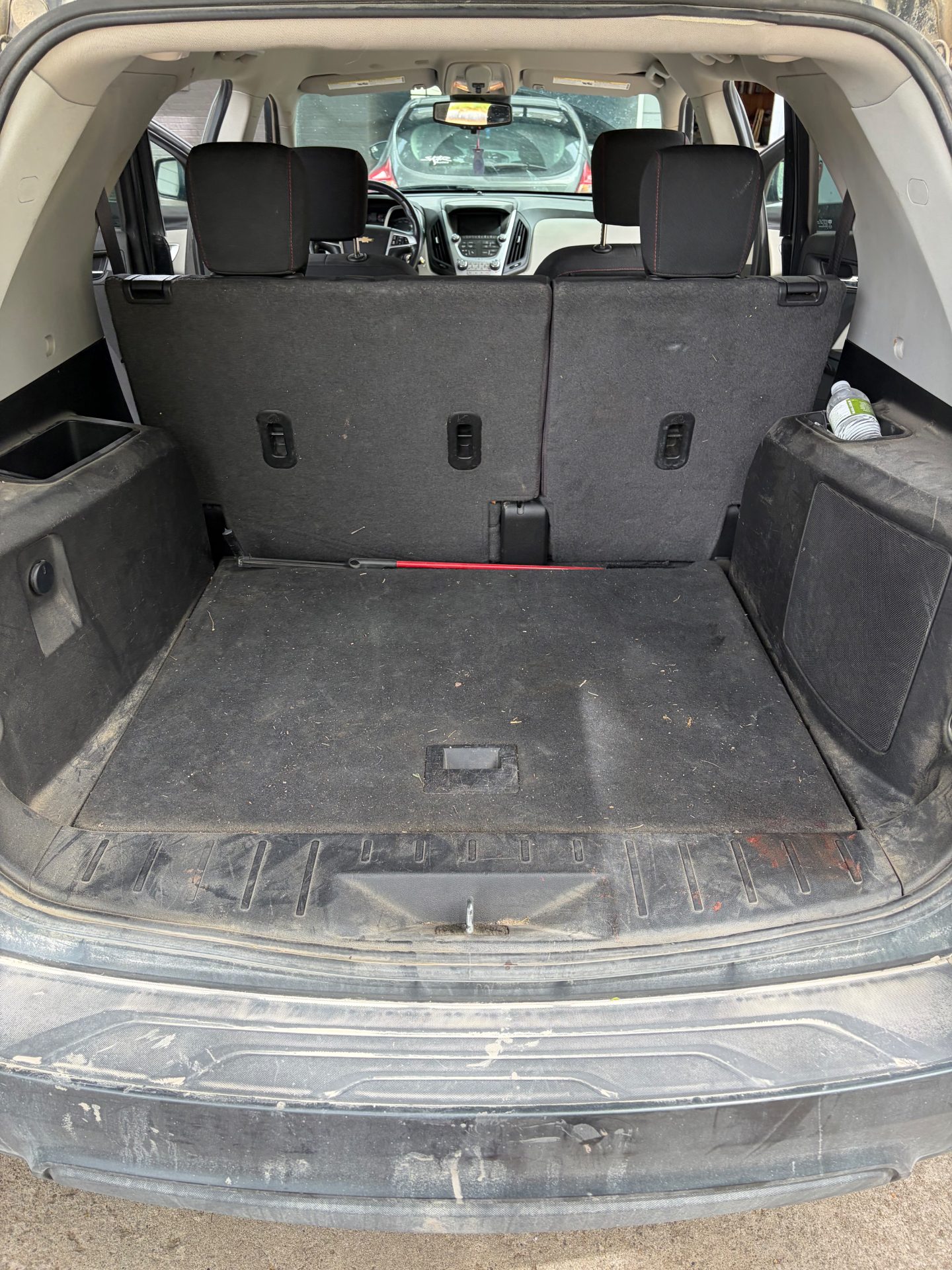 SUV cargo area before detail — dusty carpet and trim